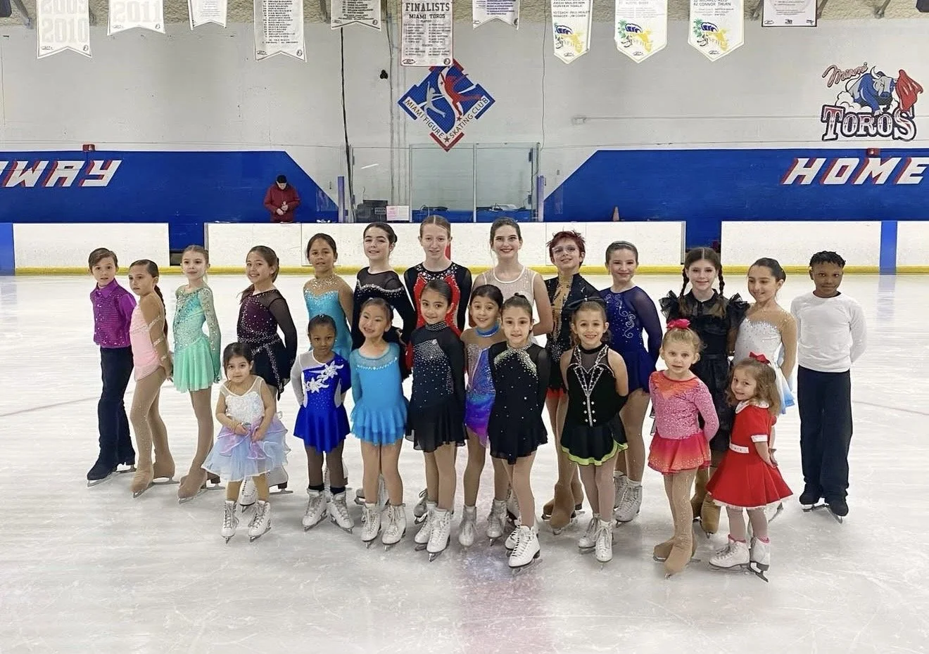 Young Miami figure skaters posing on the ice